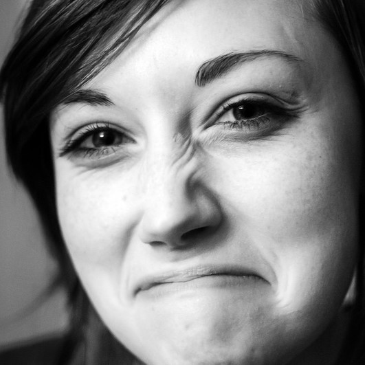 A woman with an expression of disgust or disapproval. A woman with an expression of disgust or disapproval.