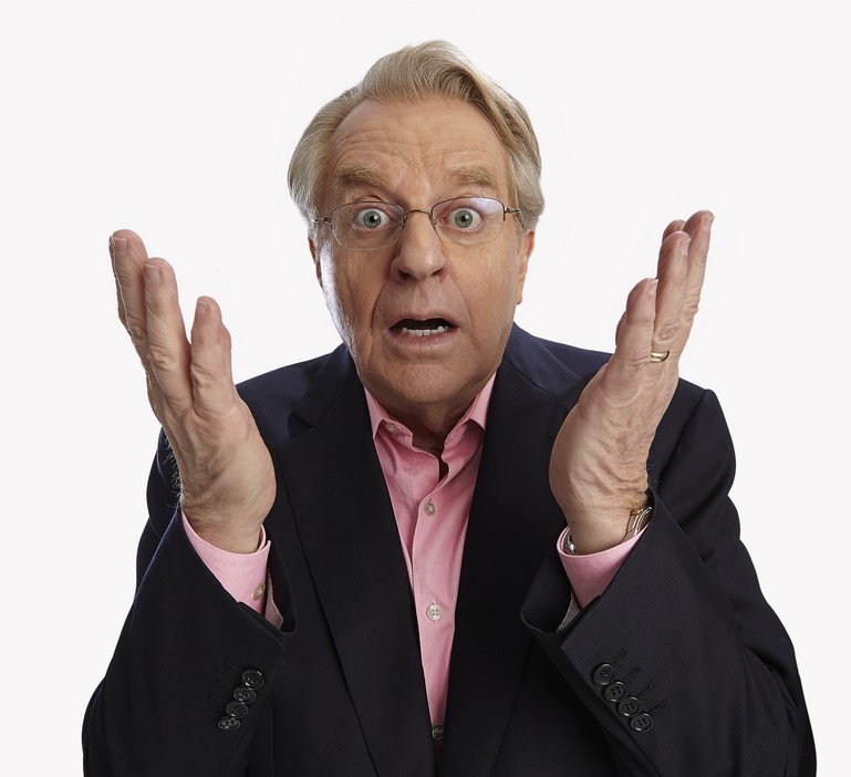 A surprised looking man holds up his hands in disbelief. A surprised looking man holds up his hands in disbelief.