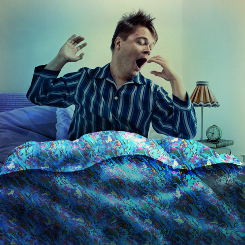 A man dressed in pajamas sits up in bed as he stretches and yawns. A man dressed in pajamas sits up in bed as he stretches and yawns.